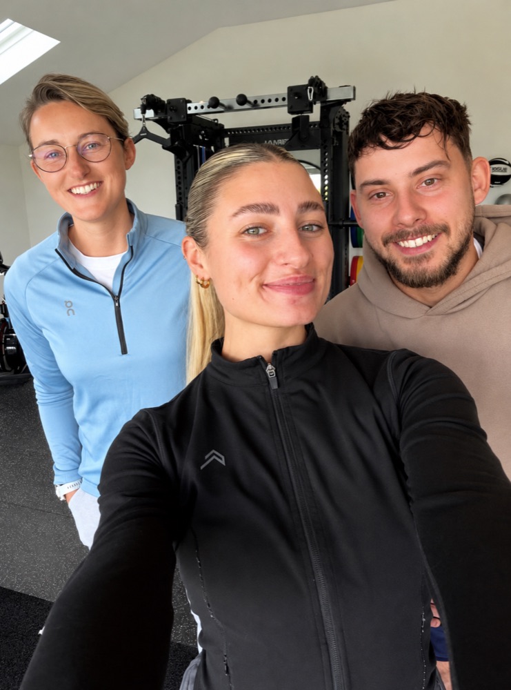 Tilly and two clients smiling in the gym